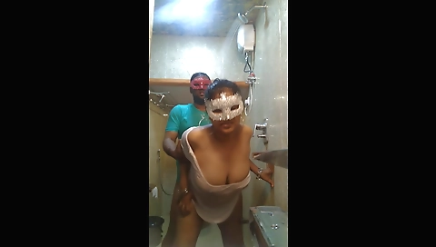 Brunette girl in the shower is showing her breasts