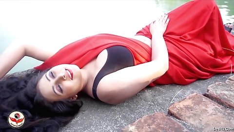 Indian babe is riding on the bike outside on her bike