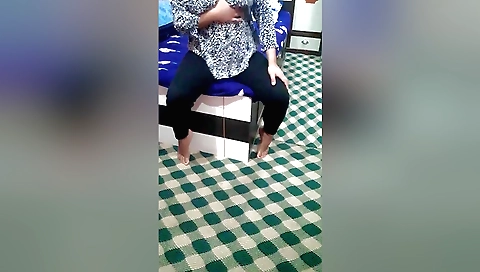 Asian female masturbating on her bed in a solo scene