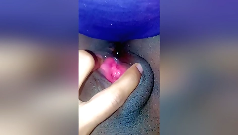 Indian girl plays with chocolate plasy on bed by herself